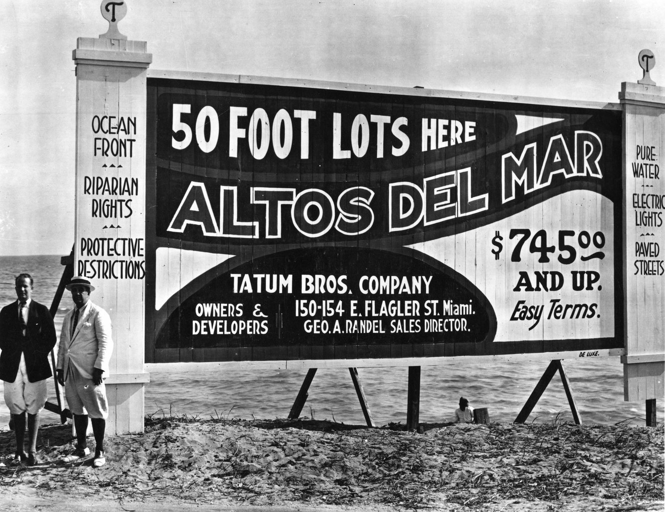 A weathered 1920s roadside billboard advertising subdivision real estate lots for sale, with hand-lettered promises and prices.
